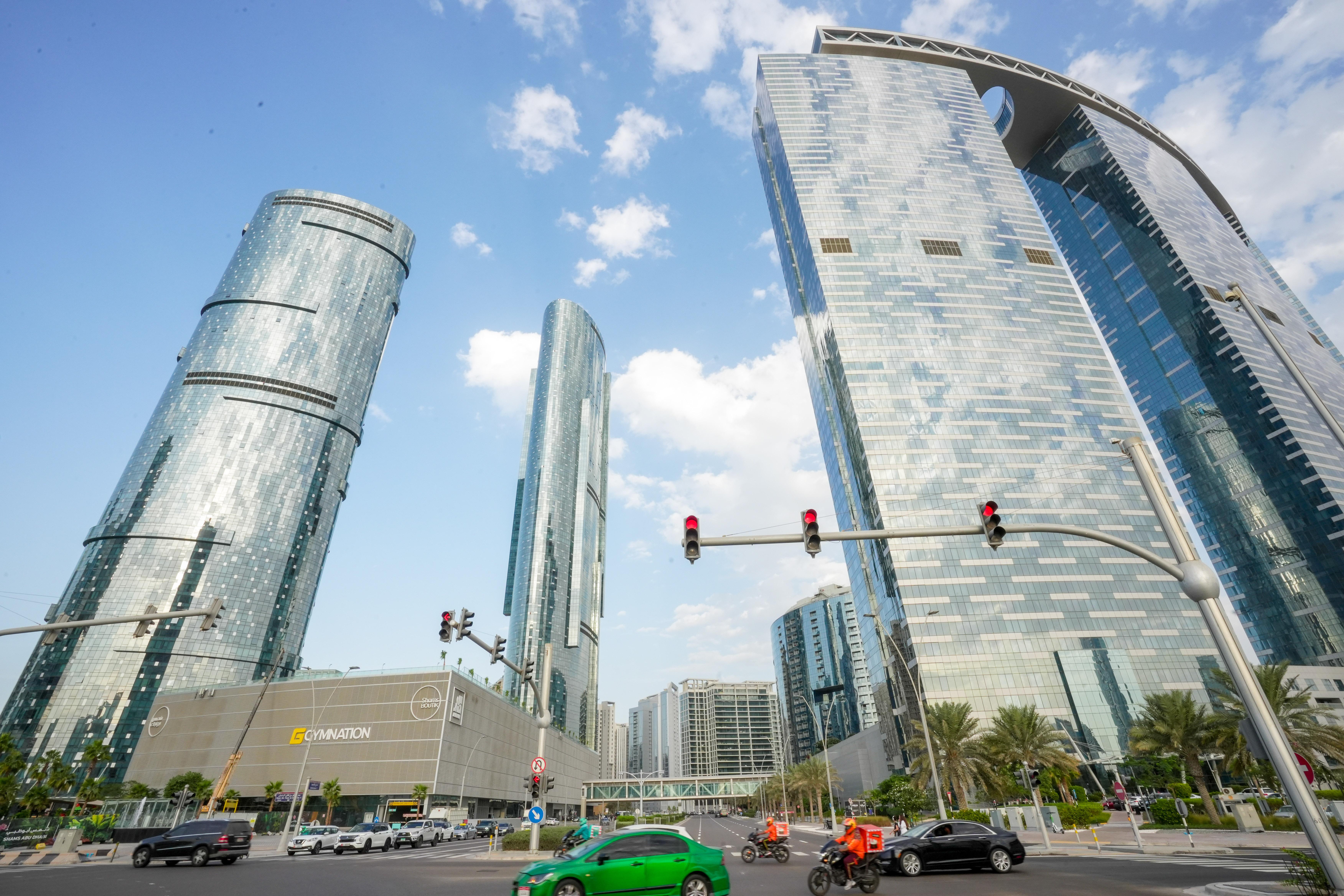 Panoramic view of the iconic three 64-storey Gate Towers and The Arc on Al Reem Island, Abu Dhabi featuring modern high-rise architecture.